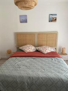 a bedroom with a large bed with two pillows at Le Refuge in Semide