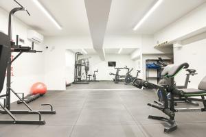 a gym with several treadmills and exercise bikes at Urban Liv Athens in Athens
