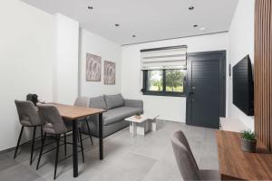 a living room with a table and a couch at ELYSIAN luxury apartments in Paliouri