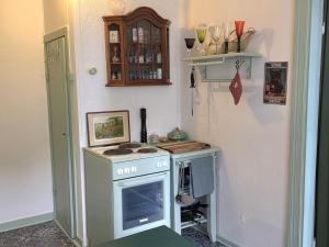 a kitchen with a stove in the corner of a room at Artist eremitage Leonora - Historic schoolhouse apartment in Fjälkinge +45 photos