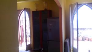 a room with two refrigerators and an arched doorway at Casa Vacanze Corso Umberto in Giardini Naxos