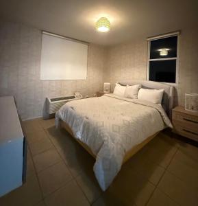 a bedroom with a bed with a white comforter at Luxury Apartment with Ocean Views in Fajardo +22 photos