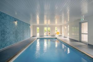 a large swimming pool in a room with a ceiling at 6 Bed in Bacton oc-2316 in Bacton