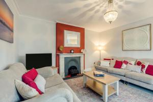 a living room with two couches and a fireplace at 6 Bed in Bacton oc-2316 in Bacton