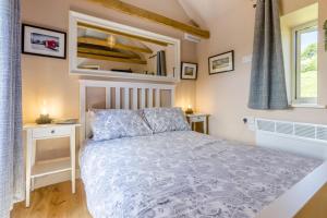a bedroom with a bed and two tables and a window at 1 Bed in Knighton oc-51898 in Beguildy