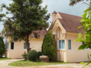 a house with a tree in front of it at silverpine khao kho in Phetchabun