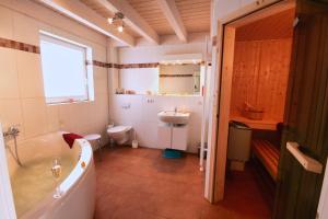 a bathroom with a tub and a toilet and a sink at Auszeit - Nordhorn in Nordhorn