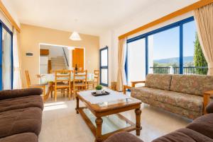 a living room with a couch and a table at Villa Charoula Ena Large Private Pool AC WiFi in Polis Chrysochous