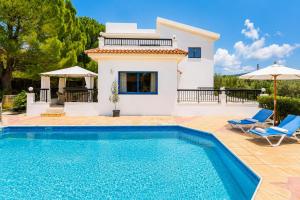 a villa with a swimming pool in front of a house at Villa Charoula Ena Large Private Pool AC WiFi in Polis Chrysochous