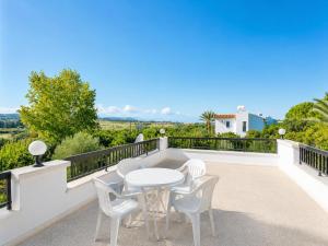 a patio with a white table and chairs on a balcony at Villa Charoula Ena Large Private Pool AC WiFi in Polis Chrysochous