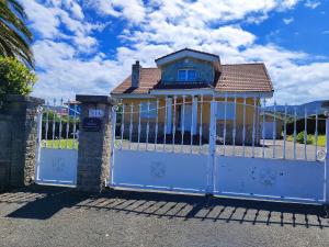 a white gate with a house on top of it at VV Las Picarolas in Muros de Nalón +83 photos