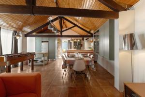 a dining room with a table and a piano at Flat 23 in Bombarral +21 photos