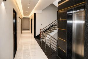 a hallway with black and white walls and stairs at Hotel Heera Palace in Khātu