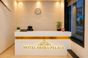 a hotel herrero palace reception desk with a clock on a wall at Hotel Heera Palace in Khātu