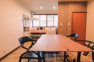 a conference room with a wooden table and chairs at rinne 北軽井沢 Forest3 in Tsumagoi
