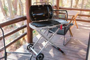 a barbecue grill on a cart on a porch at rinne 北軽井沢 Forest3 in Tsumagoi