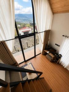 a view of a room with a large window at KALUNA cabin in Kejajar