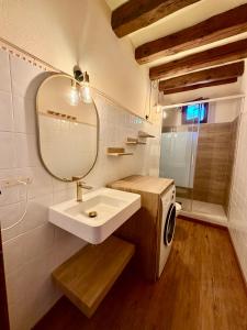 a bathroom with a sink and a mirror and a washing machine at Cal Quimet in Rialp +25 photos