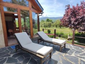 two chairs on a patio with a view at Los jardines de Osseja in Osséja
