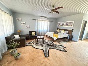 a living room with a zebra rug on the floor at Ohange Namibia Lodge in Otavi +43 photos