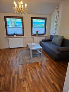 a living room with a couch and a table at Ferienwohnung in Walsrode