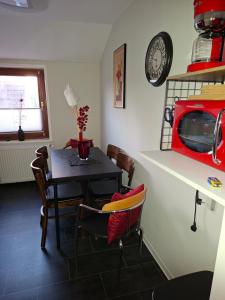 a dining room with a table and a clock on the wall at Ferienwohnung in Walsrode +11 photos