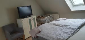 a bedroom with a bed and a tv on top at Ferienwohnung in Walsrode