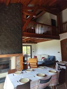 a living room with a table and a fireplace at Los jardines de Osseja in Osséja