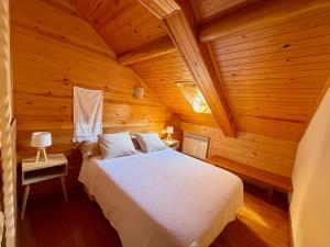 a bedroom with a bed in a wooden room at Cal Quimet in Rialp