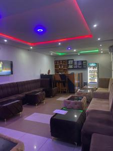 a living room with couches and a red light at Miad Hotels in Port Harcourt