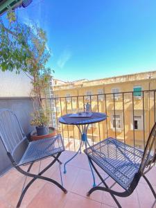 a patio with two chairs and a table on a balcony at Hotel Europeo Napoli in Naples