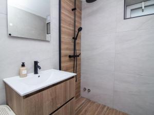 a bathroom with a sink and a shower at Old Town Spot Apartment by Stay ici in Albufeira +11 photos