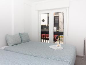 a bedroom with a bed and a window at Old Town Spot Apartment by Stay ici in Albufeira