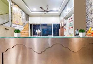 a bar in a restaurant with a counter top at Hotel Amaravathi Residency in Guntūr