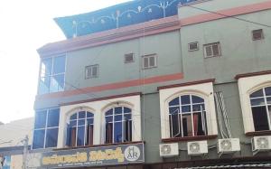 a building with a sign on the side of it at Hotel Amaravathi Residency in Guntūr