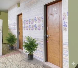 a door with plants in front of a building at Hotel Amaravathi Residency in Guntūr
