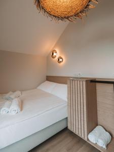 a bedroom with two beds and a chandelier at Palmera in Władysławowo +50 photos