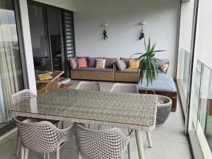a balcony with a table and chairs and a couch at Nou Lakaz in Rose Hill