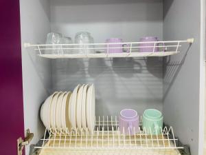 a closet with plates and bowls on a shelf at Elegant Home Apart in Karagandy +2 photos