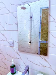 a bathroom with a mirror and a sink at Zanzibar Apartment 1 in Kibele +33 photos