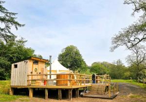 a large wooden house with a ramp and a tent at Roden Retreat in Aston