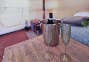 a bottle of wine in a bucket on a wooden table at Roden Retreat in Aston