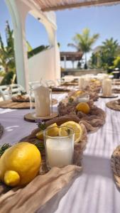 a long table with lemons and glasses of milk at VILLA8 in Puerto de Santiago