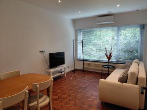 a living room with a couch and a table at TML Parkview Apartment in Boom
