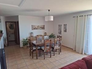 a dining room with a table and chairs at Pôr do Sol in Estreito da Calheta +12 photos