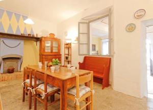 a dining room with a table and a couch at Villa Ca' Vegia in Stresa