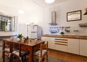a kitchen with a wooden table and a refrigerator at Villa Ca' Vegia in Stresa