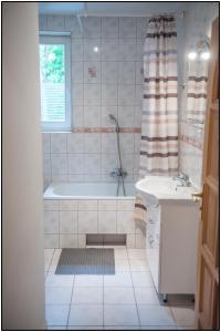 a bathroom with a tub and a sink and a shower at Mazury- dom wakacyjny in Pisz +29 photos