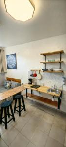 a kitchen with a wooden table and a sink at Loft #1 a una cuadra de Playa Regatas Oyster Suites in Veracruz