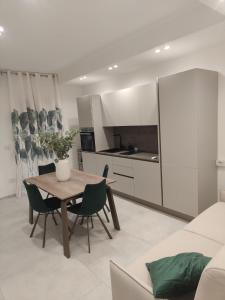 a kitchen and dining room with a table and chairs at AnnAmuri in Belpasso +8 photos